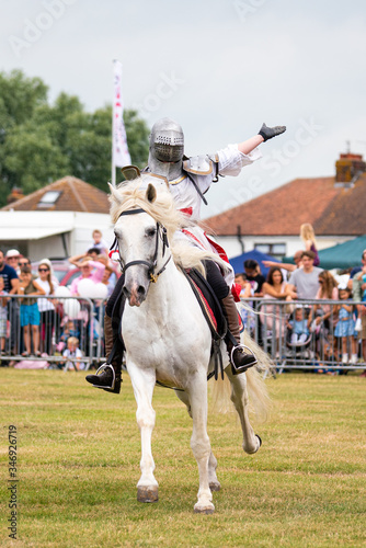 Knight on a horse waving to the crowd