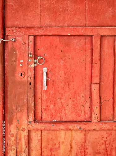 A rustic red door at Klima Fishing Village - Milos Island, Greece