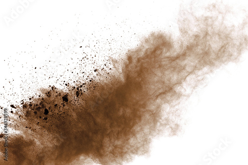 Explosion of brown powder on black background.