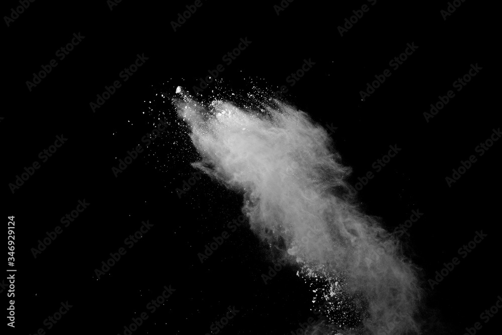 Freeze motion of white color powder exploding on black background. Freeze motion of white color powder exploding on black background.