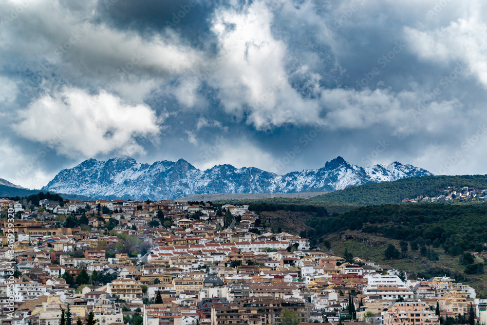 Beautiful Winter View Over a Snowy Mountain. Snow clouds over a village in the snowy mountains of the Sierra Nevada of Spain.