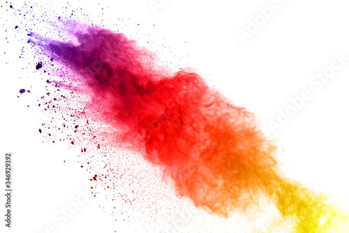 Colorful powder explosion on white background.Pastel color dust particle splashing.