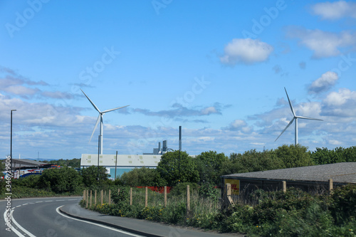 Windmill turbine on the field in UK with blue sky