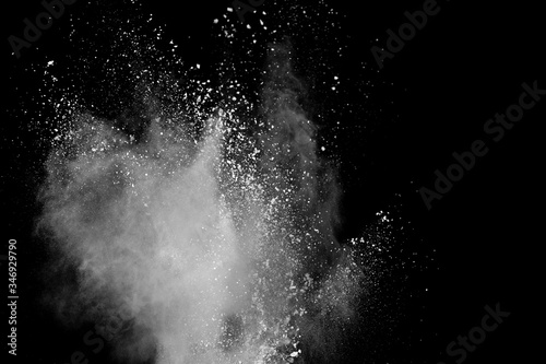 Fototapeta Naklejka Na Ścianę i Meble -  Freeze motion of white color powder exploding on black background.