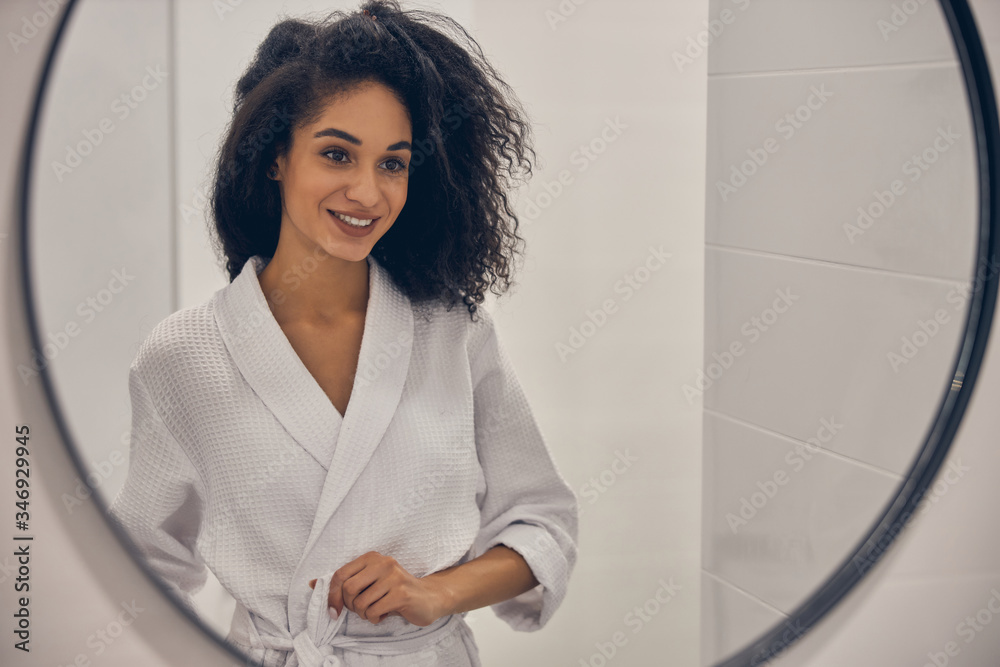 Girl smiling at herself in the mirror Girl smiling at herself in the mirror