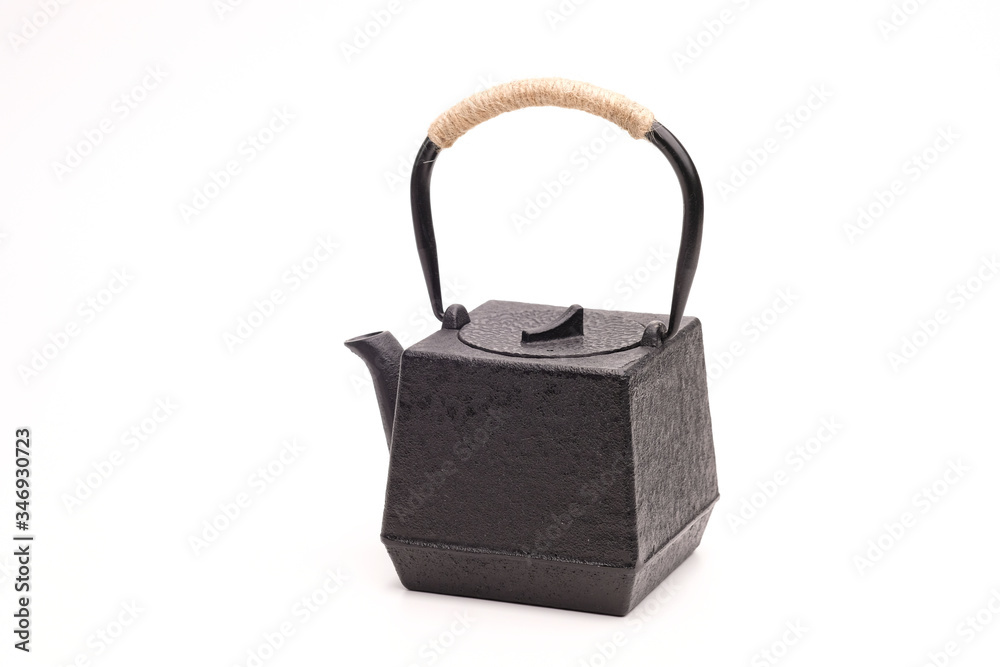 Black metal cast-iron traditional teapot on white background. Black metal cast-iron traditional teapot on white background.