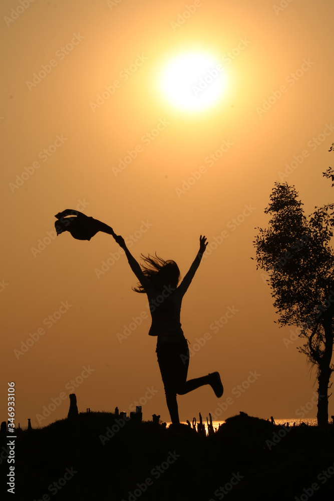 silhouette of a woman jumping
