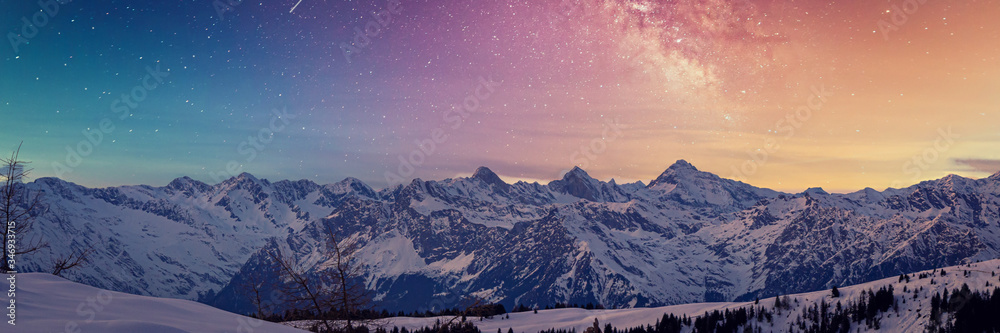 Fototapeta Snowy rocky mountain with a beautiful starry night, space fort text