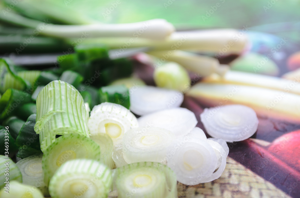 Sliced green onions on a glass tray. Side sunlight. Sliced green onions on a glass tray. Side sunlight.