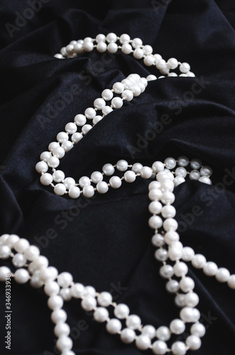 Pearl bracelet on black fabric. Pearl beads. Wedding decoration for a gift. Elegant necklace for women.