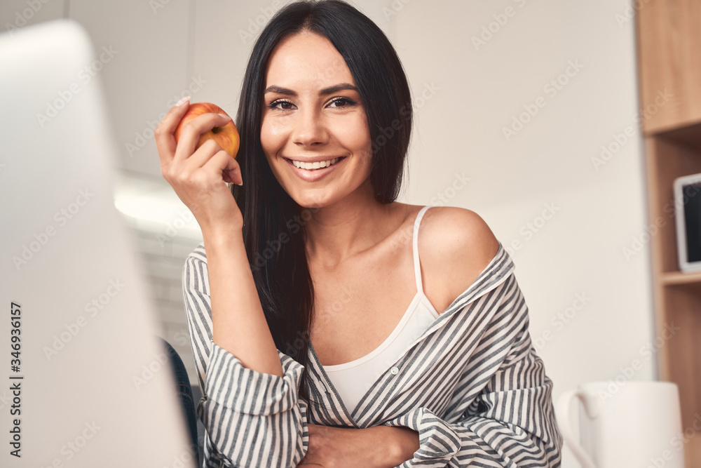 Positive delighted young woman looking at camera Positive delighted young woman looking at camera