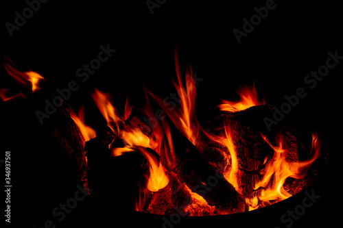 Burning firewood close-up in the dark