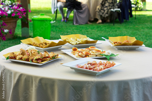 Snacks on the wedding table. Croissants, cold cuts. Outdoor wedding.