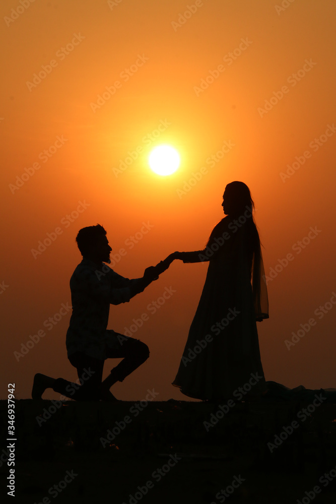 silhouette of a couple on the beach at sunset