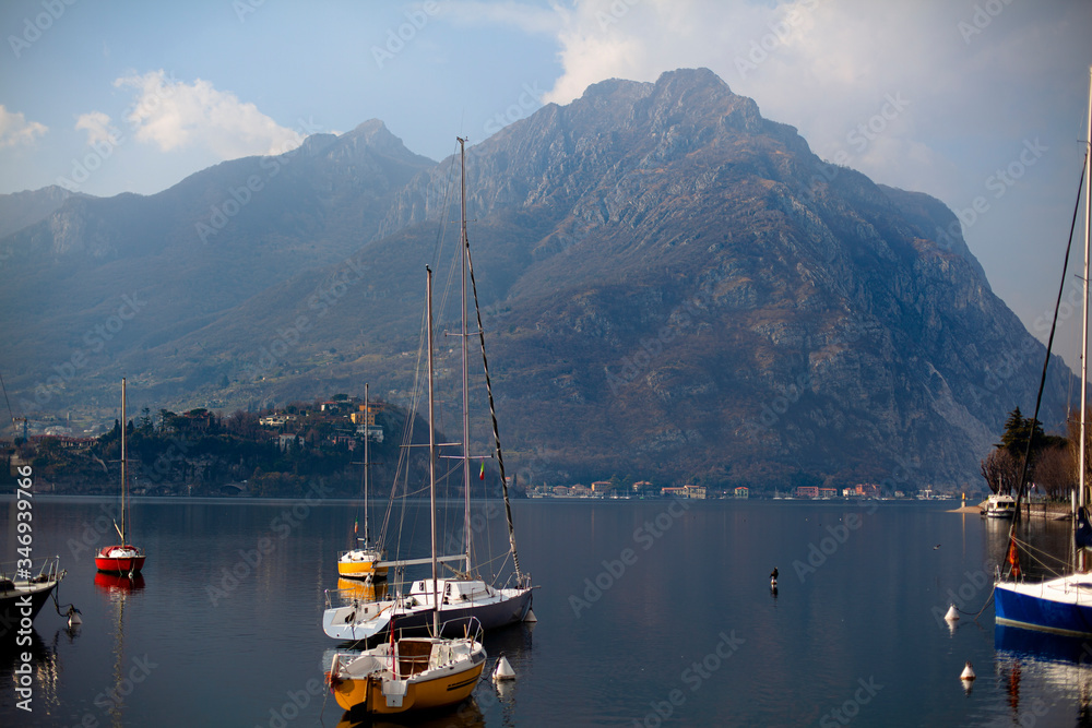 Front View at Como Lake with boats and Big Mountains.  Landscape View at Lecco city, Lombardy, Italy.