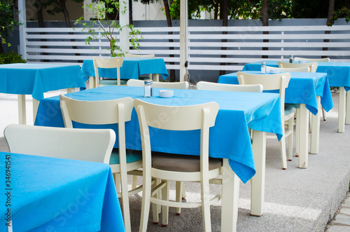 Cozy summer cafe. Tables and chairs on outdoor terrace.