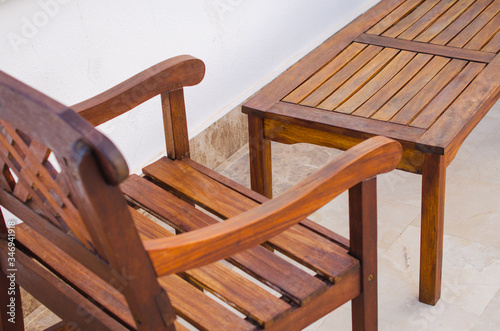 Cozy summer cafe. Wooden tables and chairs on outdoor terrace.