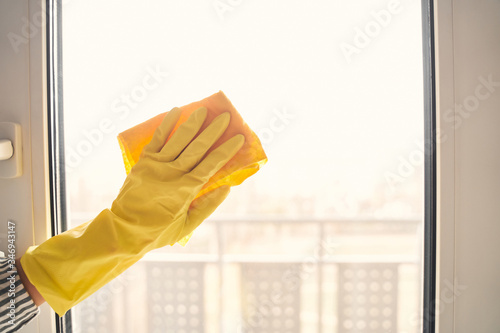 Close up of female hand that cleaning glass