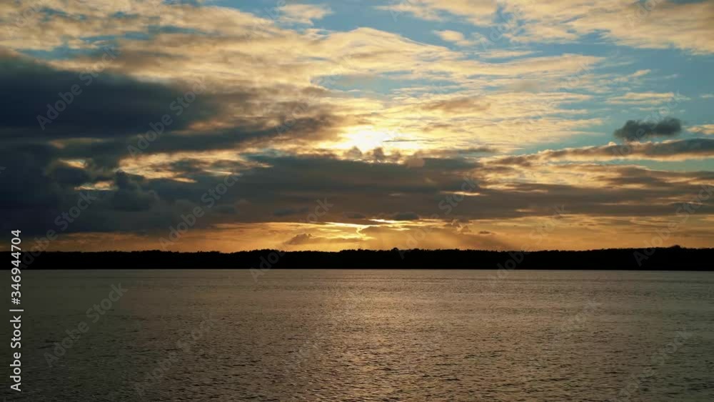 Gorgeous golden sunset on a large river at Alligator Beach near Joao Pessoa, Brazil Gorgeous golden sunset on a large river at Alligator Beach near Joao Pessoa, Brazil