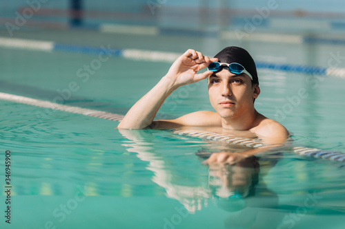 Male swimming instructor posing in the swimming pool
