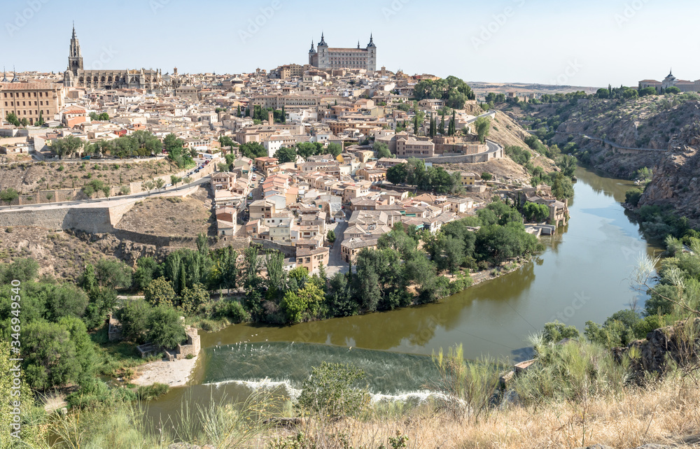 panoramic view on toledo medieval city with castle and river