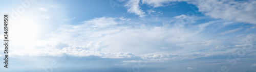 Blue sky with clouds and sun panoramic web banner