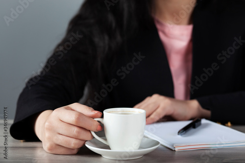 woman drink coffee and lilac on table