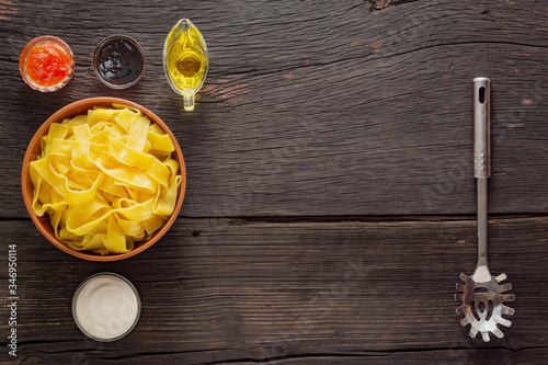 Pappardelle pasta with salmon. italian traditional cuisine. Finished ingredients on a wooden table with copy space.