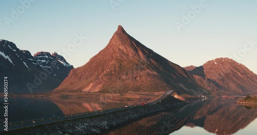 Aerial shot of four isolated cars driving in Lofoten, Norway  in sunset. 