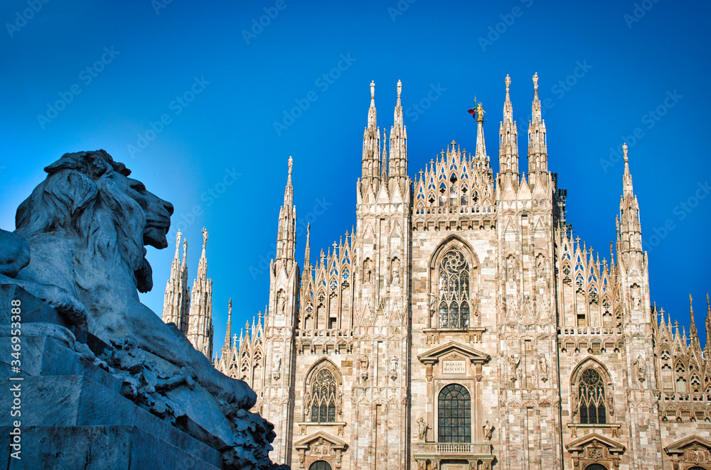 The golden sunshine is reflecting on the front of the magnificent Duomo di Milano or Milan Cathedral after Italy eases coronavirus restrictions