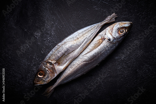 Two horse mackerels on the kitchen table. photo