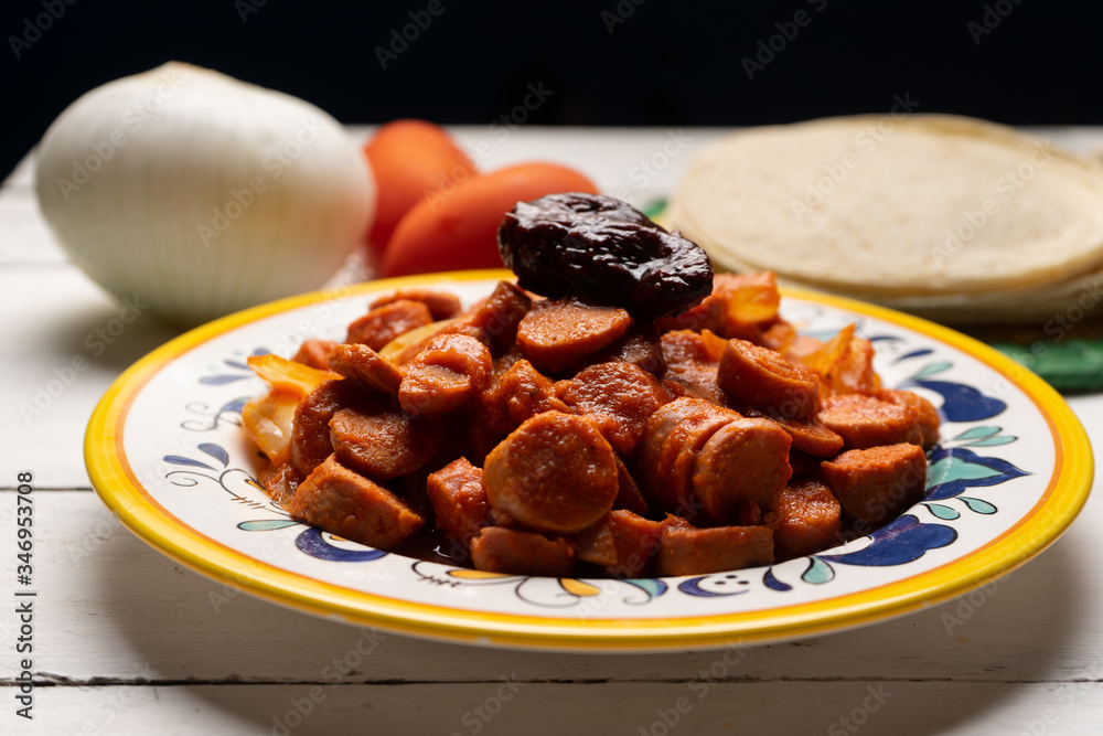 Mexican sausage with chipotle sauce on white background