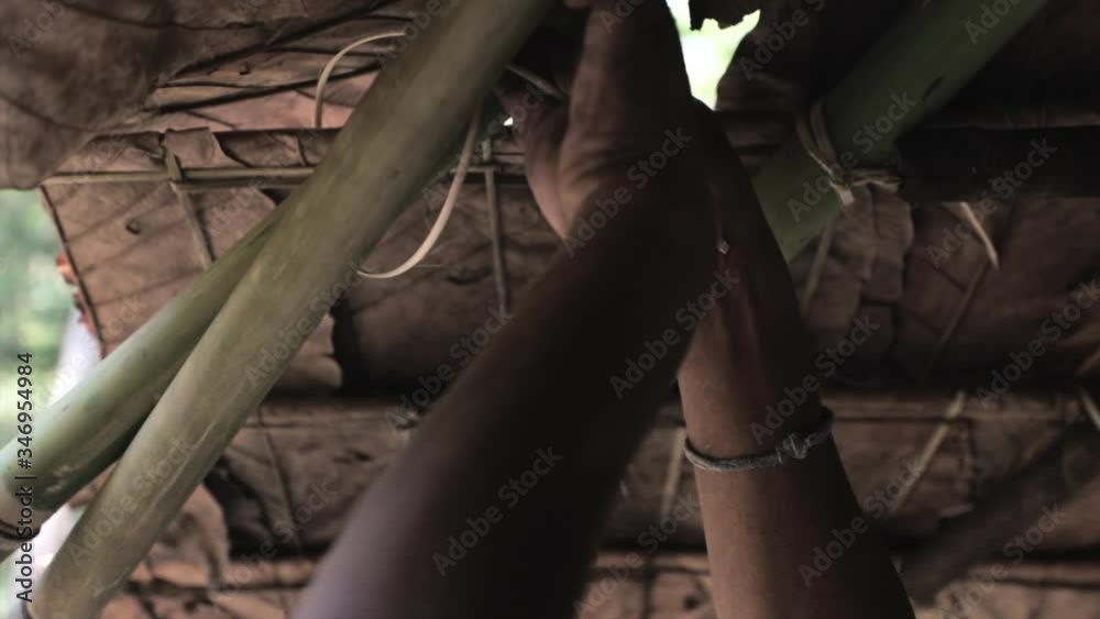 Man making a Bamboo house in Thailand Man making a Bamboo house in Thailand