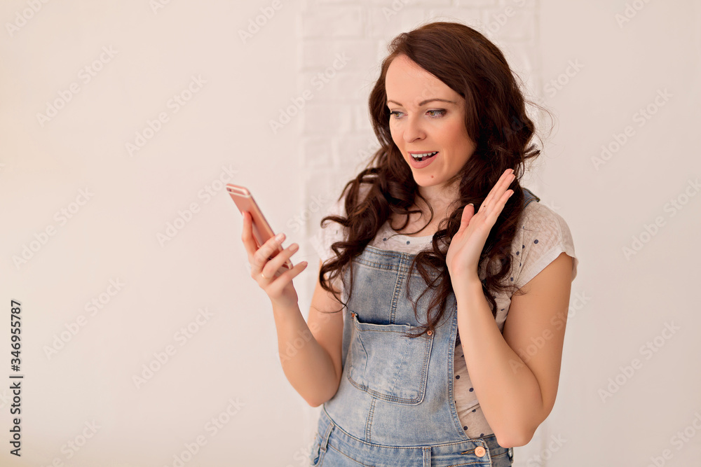 Beautiful woman taking a selfie at home. Young cute girl talking via video link to a mobile phone with friends or relatives. Beautiful woman taking a selfie at home. Young cute girl talking via video link to a mobile phone with friends or relatives.