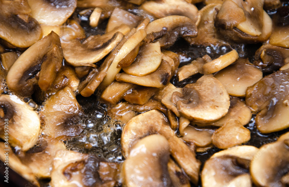 Chopped champignon mushrooms are fried in a pan. Pizza Mushrooms Chopped champignon mushrooms are fried in a pan. Pizza Mushrooms