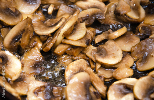 Chopped champignon mushrooms are fried in a pan. Pizza Mushrooms
