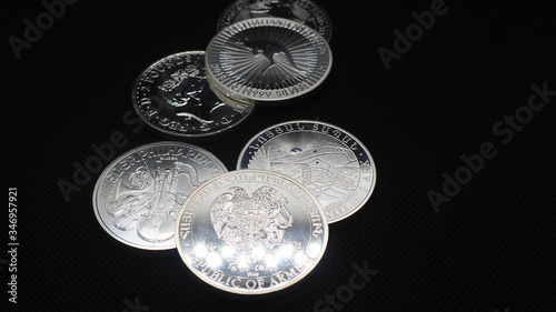 Silver coin oz, ounce, on black background © Búho