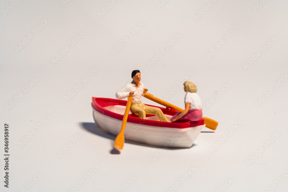 Obraz premium miniature figure of kayaking, rowing the boat