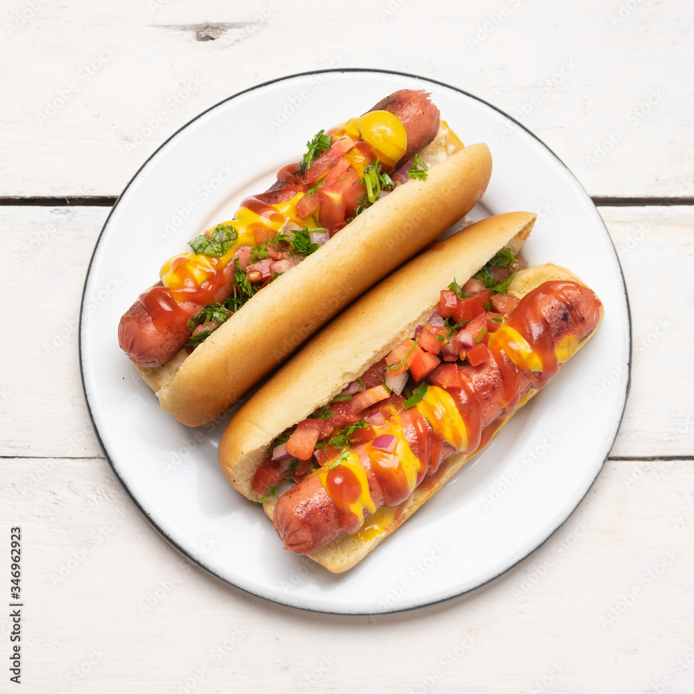 Hot dog with pico de gallo salad on white background