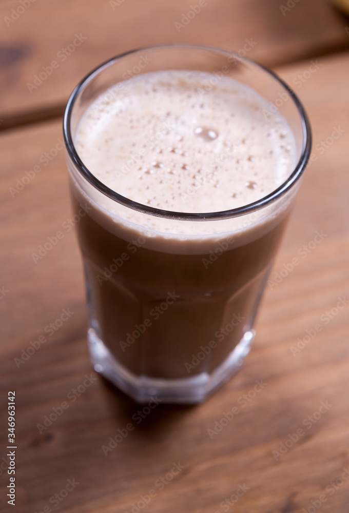 glass of cappuccino on a wooden table glass of cappuccino on a wooden table