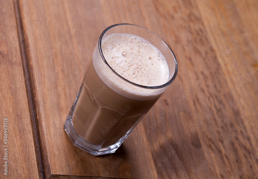 glass of cappuccino on a wooden table