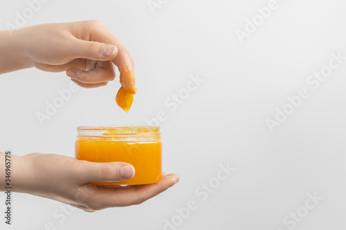 Orange scrub, jelly peeling in a woman's hand