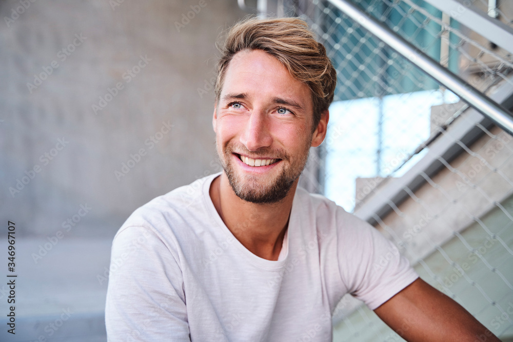 Portrait of smiling young man wearing white t-shirt Portrait of smiling young man wearing white t-shirt