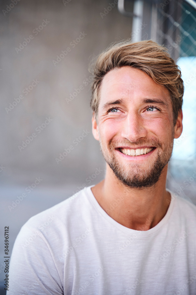 Portrait of smiling young man wearing white t-shirt Portrait of smiling young man wearing white t-shirt