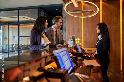 Business people at reception desk in hotel lobby