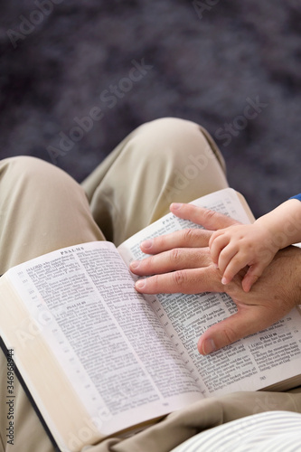 Grandpa Reading to Baby Boy From the Bible