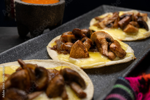 Mexican quesadillas with mushrooms on dark background