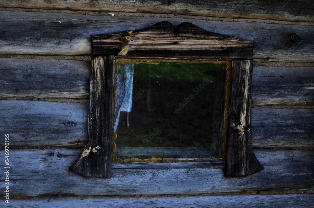 wooden window of an old bath in the village in the summer on the rest of the Russian bath on black