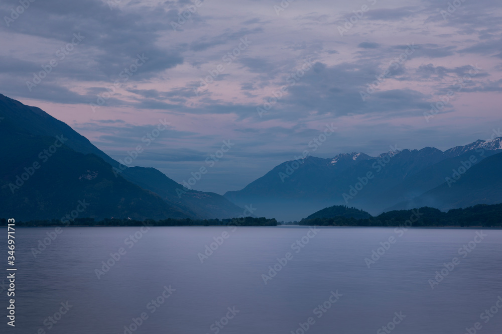 Sunset at Lake Comersee, mountains in background, clouds in sky, Italy.