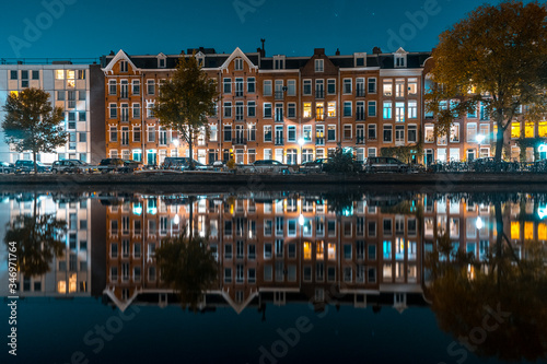 Beautiful smooth reflection of a residential area over the river in Amsterdam.